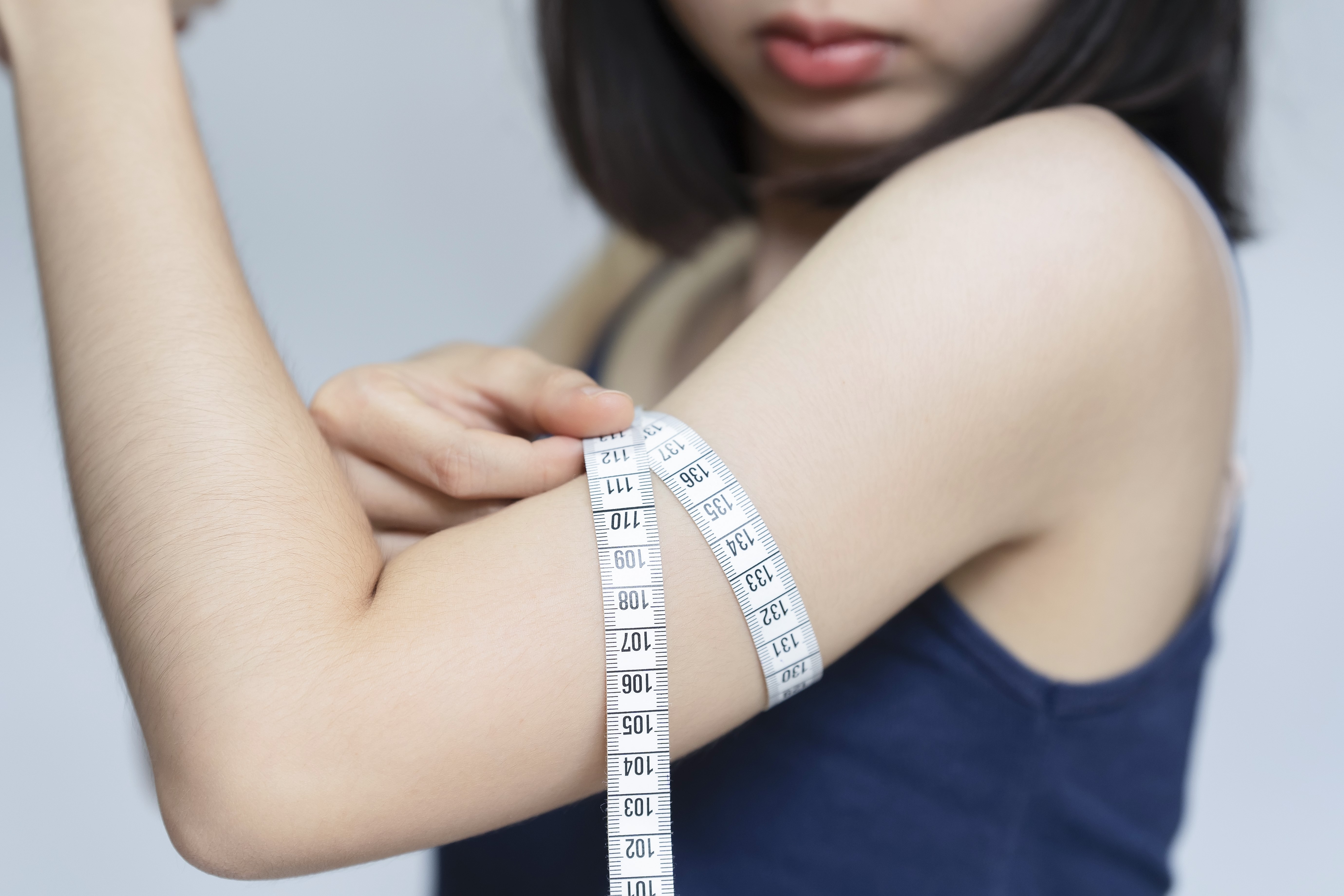 woman-measuring-proportions-her-upper-arm-with-tape-measure-after-exercise.jpg